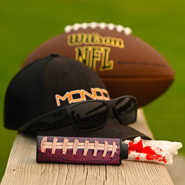 Monocz pocket monocular, two-tone shell, resting on a ballcap
